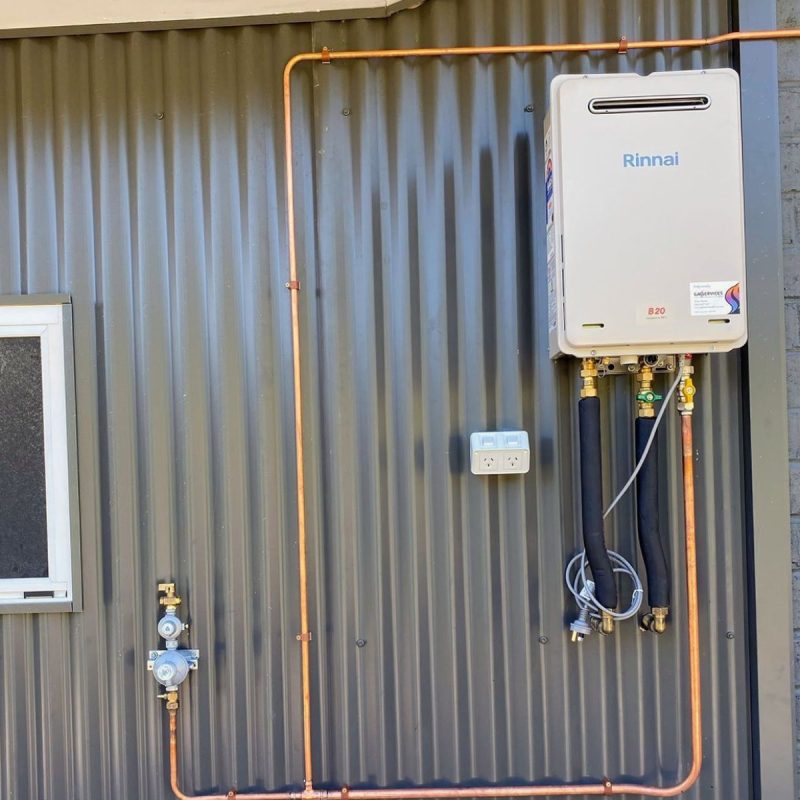 Rinnai continuous flow hot water unit on a corrugated wall with a copper gas run and isolation valves